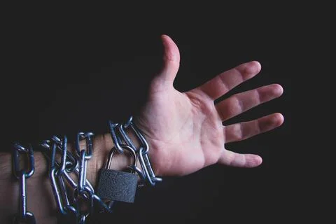 Chain and lock on hand. Arrest of a criminal. Handcuffs on the prisoner. Stock Photos