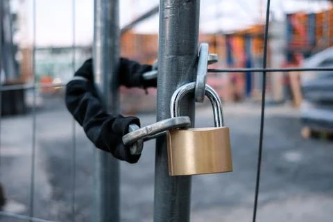 Chain and padlock on gate at construction site Stock Photos