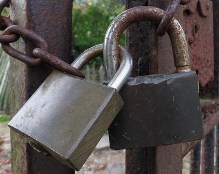 Chain and padlocks on a rusty metal gate Stock Photos