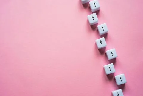 Chain of arrows blocks on a pink background. Concept of conformism, vertic... 写真素材
