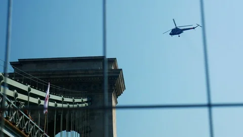 Chain Bridge and a helicopter behind security fence at public holiday Stock-Footage 103167114