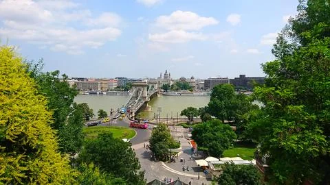 Chain Bridge spanning the Danube River with vibrant green parks and trees Stock Photos
