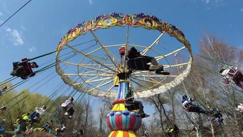 Chain carousel spinning in slow motion in the park on the sunny day, Almaty Video stock 237831334