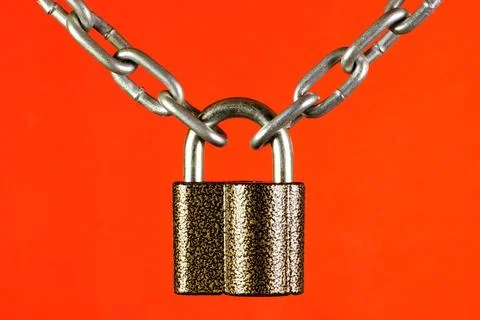 The chain is connected by a lock, on a red background. The concept of secur.. Stock Photos