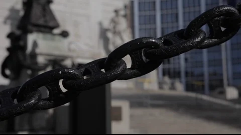 Chain in front of out of focus downtown monument Stock Footage 102347616