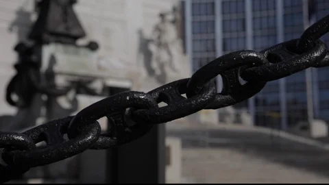 Chain in front of out of focus downtown monument Stock Footage 102347664