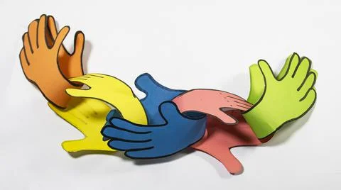 A chain of hand shape made by different colored paper that locked one into an Stock Photos