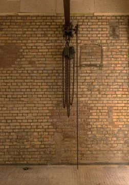 Chain hoist for lifting weights in an old factory Stock Photos