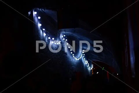 A chain of light bulbs in a tunnel Stock Photos