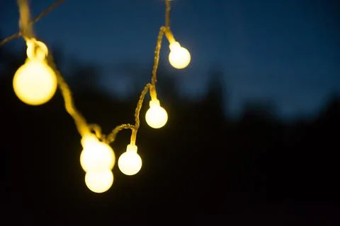 Chain of lights brings light into the dark night - a cozy atmosphere Stock Photos
