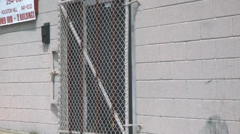 Chain link fence and cement building Stock Footage 33245366