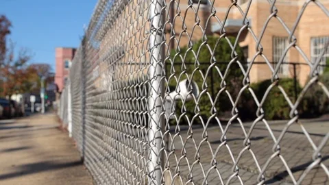 Chain link fence on angle and sidewalk 動画素材 98435680