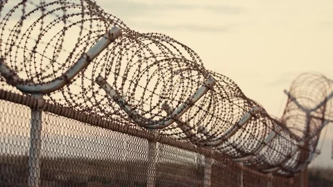 Chain link fence with barbed wire on top Stock Footage