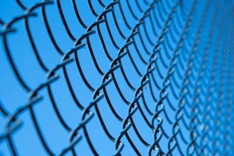 Chain link fence on blue sky Stock Photos
