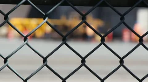Chain Link Fence with Flurred Background Workers Stock-Footage 11018619