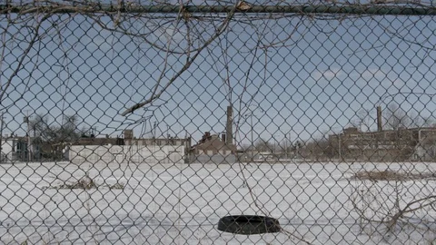 Chain link fence in front of parking lot in inner city winter Stock Footage 89945008