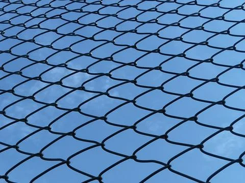 Chain Link Fence Pattern Against Blue Sky_02 Stock Photos