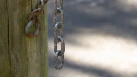 Chain Link Hanging from Wooden Gate Post, 4K Stock Footage 72879204