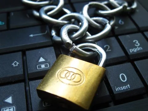 Chain with lock on computer keyboard. Banned. Symbol of addiction Photos
