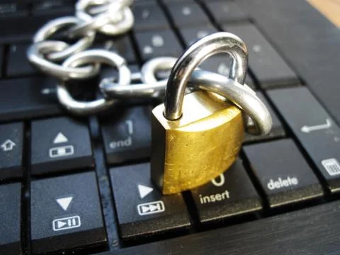 Chain with lock on computer keyboard 스톡 사진