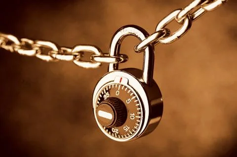 A chain locked by a lock Stock Photos