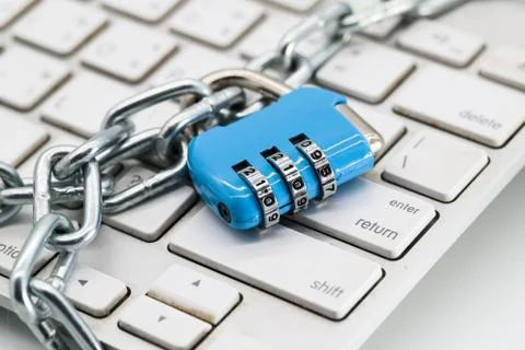 Chain locked with password protection on computer keyboard Stock Photos