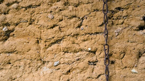 Chain on a mud old ancient wall Video stock 94638837