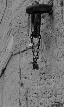 Chain with padlocks on a stone wall Stock Photos