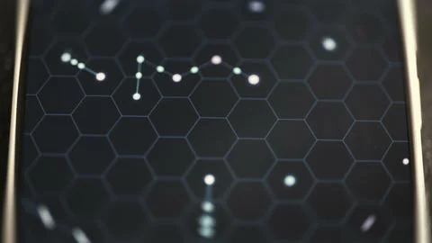 Chain of small luminous nodes links across a dark hexagonal grid Stock Photos