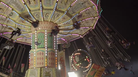 Chain swing ride at amusement park at night. 4K UHD. 스톡 동영상 54297904