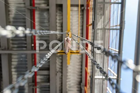 Chain winch for lifting loads inside shop premises at plant Stock Photos