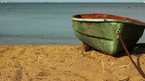 Chained emerald boat on sandy beach. static waterscape background Stock Footage 122524929
