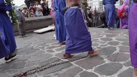 Chained man carrying heavy log during Jesus del Gran Poder procession in Ecuador Stock Footage 333485264