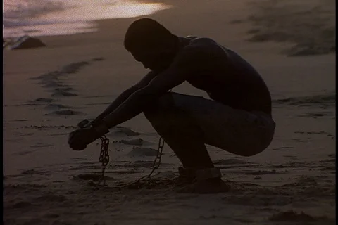 Chained man raises arms to the sun Stock Footage 86751459
