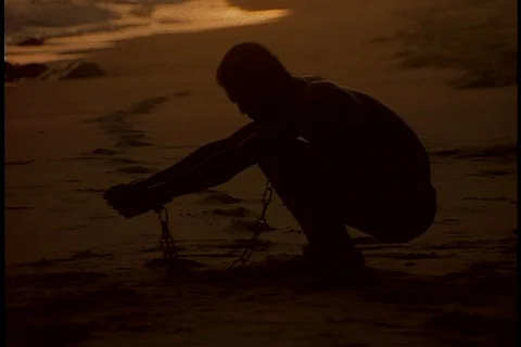 Chained man raises arms to the sun Stock Footage 86751464