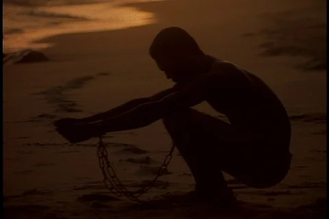 Chained man raises arms to the sun Stock Footage 86751467