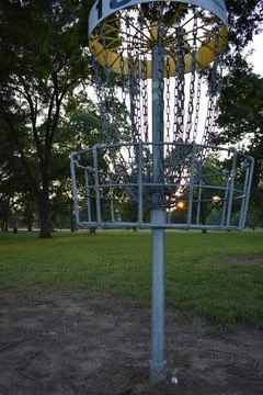 Chains Disc Golf Basket at Sunset in a City Park 스톡 사진