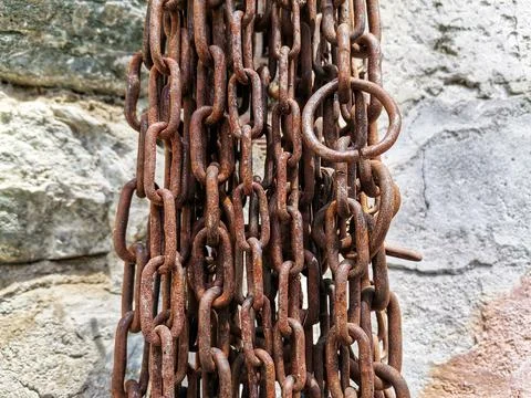 Chains hanging on the wall. Stock Photos