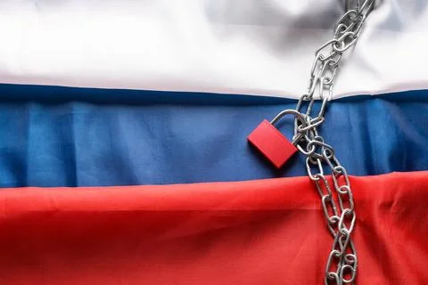 Chains with lock on flag of Russia. Sanctions concept Stock Photos