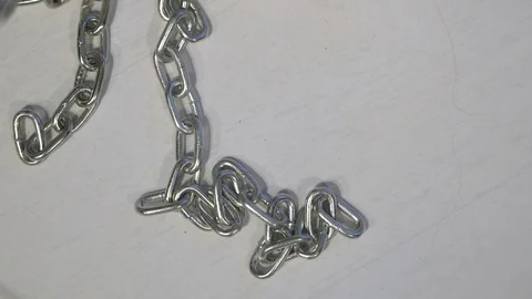 Chains roll in on a white background 스톡 동영상 122573772