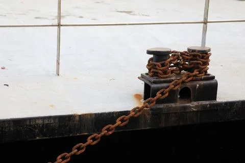 Chains securing ships to the pier Stock Photos