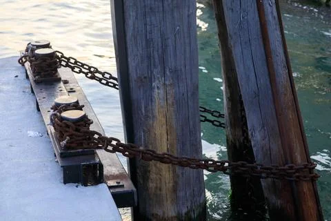Chains securing ships to the pier Stock Photos