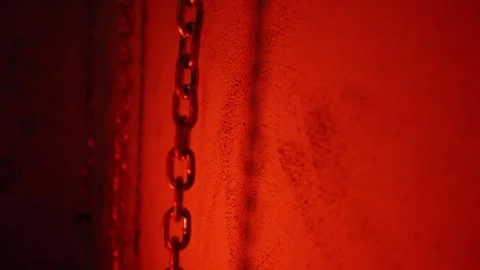 Chains on a Wall in a Horror Room with red Colored Light Video stock 309481252