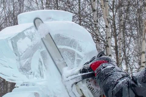 Chainsaw and ice. Stock Photos