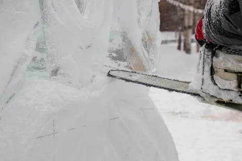 Chainsaw and ice. Stock Photos