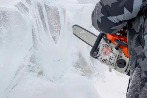 Chainsaw and ice. Stock Photos