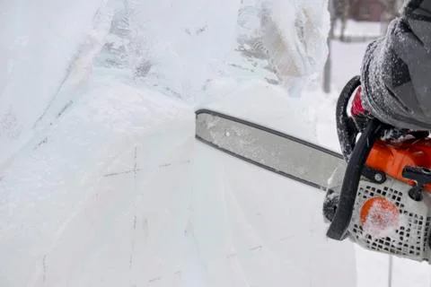 Chainsaw and ice. Stock Photos