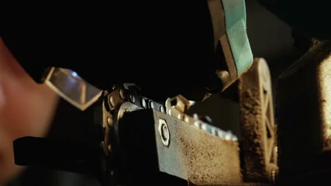 Chainsaw blade sharpening by male on a sharpener in a lamp light. Video stock 131313593