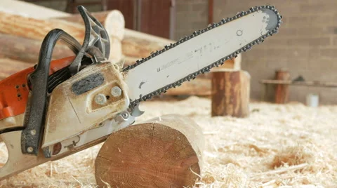 Chainsaw builder at the site of construction of a wooden house. Many sawdust and Stock Footage 69058160