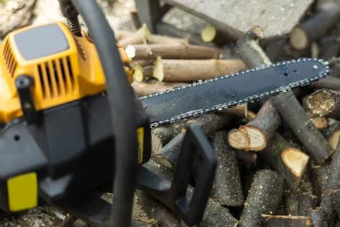 Chainsaw close up. Chainsaw with a tool. Chainsaw on the background of firewo Stock-Fotos